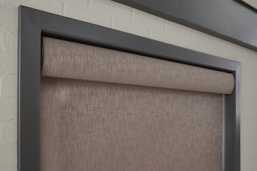 A close-up image of a roller shade with customized brown hatched fabric 